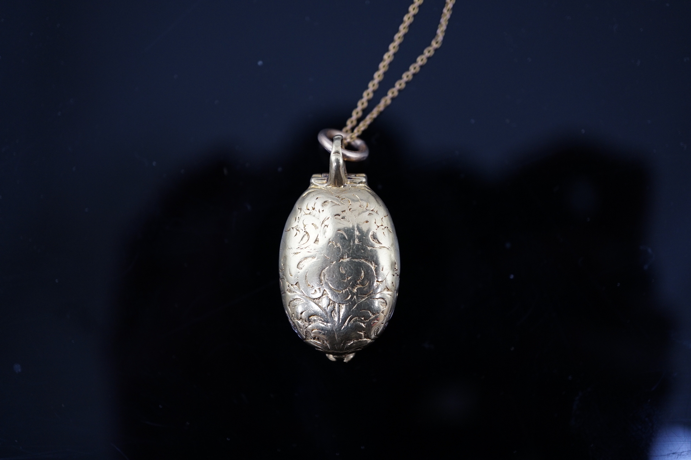 A 19th century engraved gold and inset cameo agate set oval locket, on a fine link gold chain